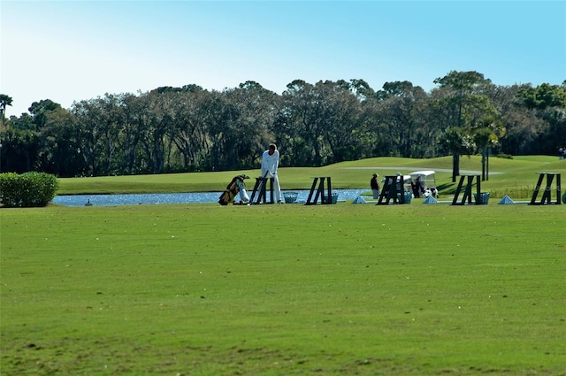 view of home's community featuring a water view and a lawn