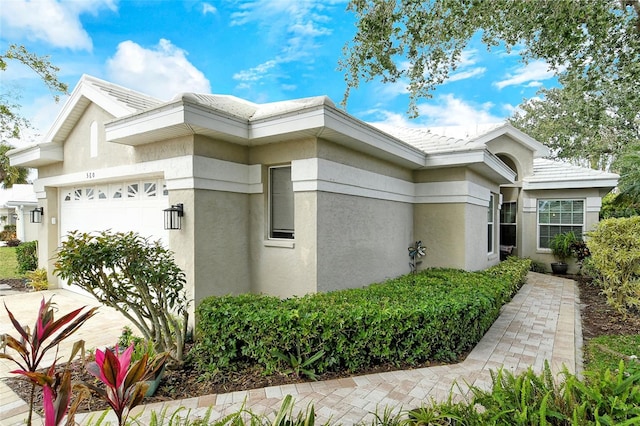 view of home's exterior featuring a garage and stucco siding