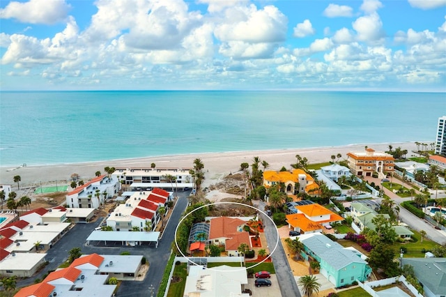 aerial view with a water view and a beach view