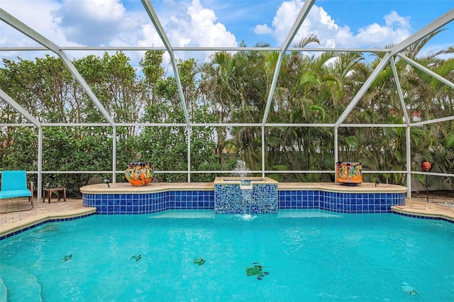 view of pool featuring pool water feature, a patio, and a lanai