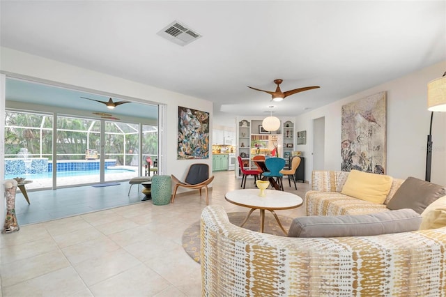 living room with ceiling fan and light tile patterned floors