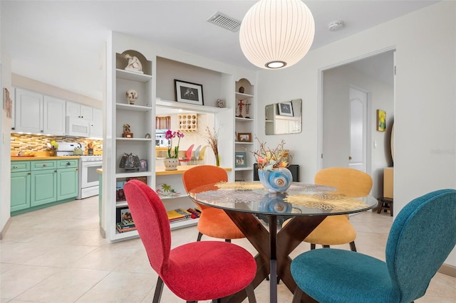 dining space featuring light tile patterned floors and built in features