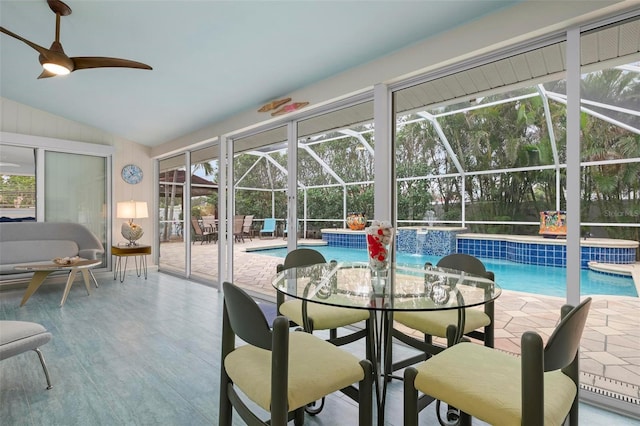 sunroom with ceiling fan and lofted ceiling