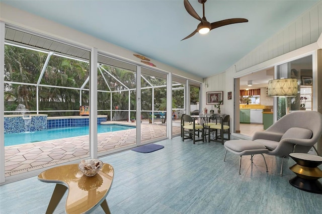 view of pool with ceiling fan and pool water feature