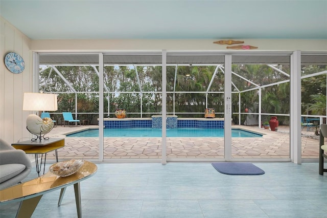 view of swimming pool with a lanai, pool water feature, and a patio area