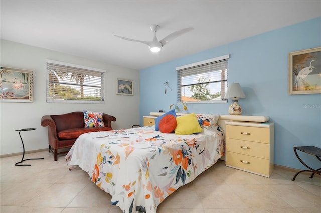 bedroom featuring ceiling fan, light tile patterned floors, and multiple windows