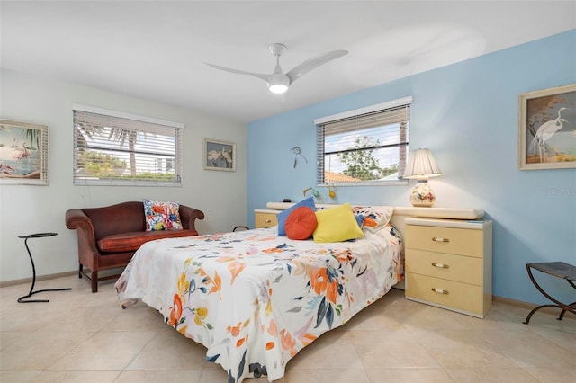 tiled bedroom featuring ceiling fan and multiple windows