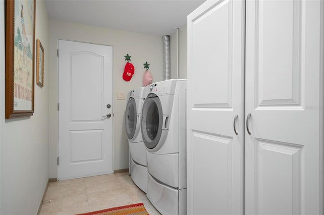 washroom featuring light tile patterned floors and washing machine and clothes dryer