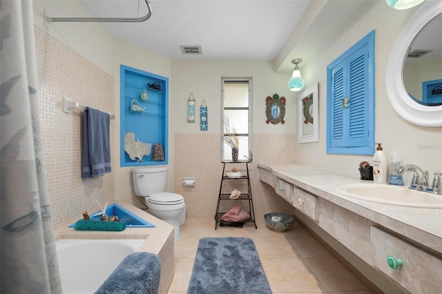 bathroom featuring toilet, a bathtub, tile walls, tile patterned floors, and built in shelves