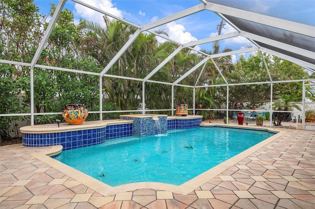 view of swimming pool with a lanai, pool water feature, a hot tub, and a patio