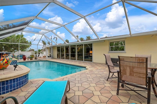 view of swimming pool with a patio area and a lanai