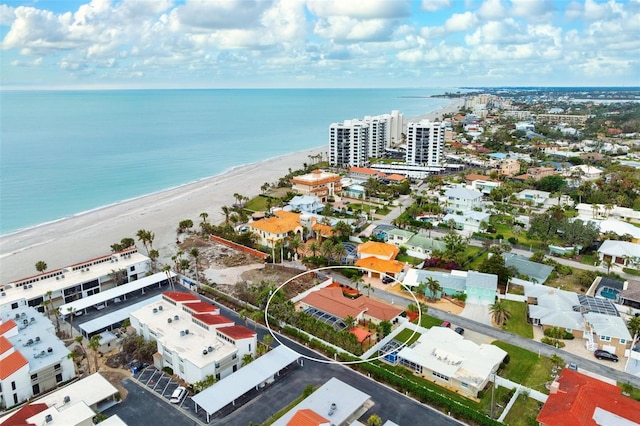 birds eye view of property featuring a water view and a view of the beach