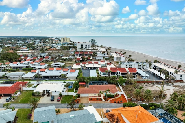 bird's eye view with a water view and a beach view