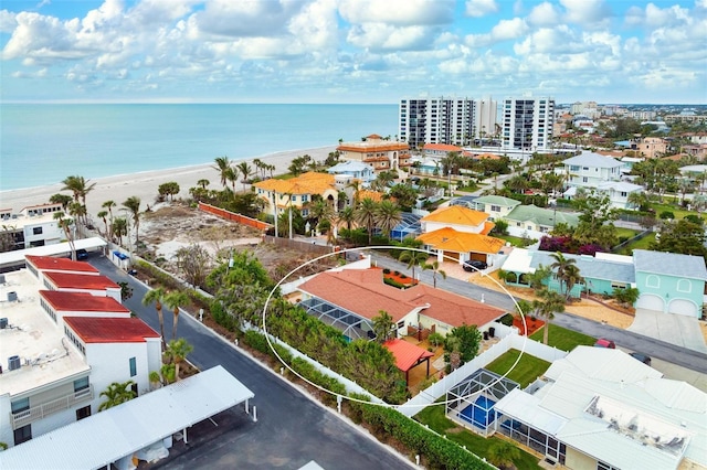 birds eye view of property with a water view and a beach view