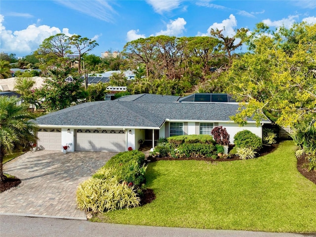 single story home with a garage and a front lawn