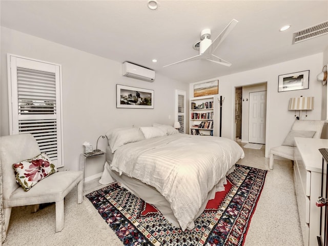 bedroom with ceiling fan and a wall mounted AC