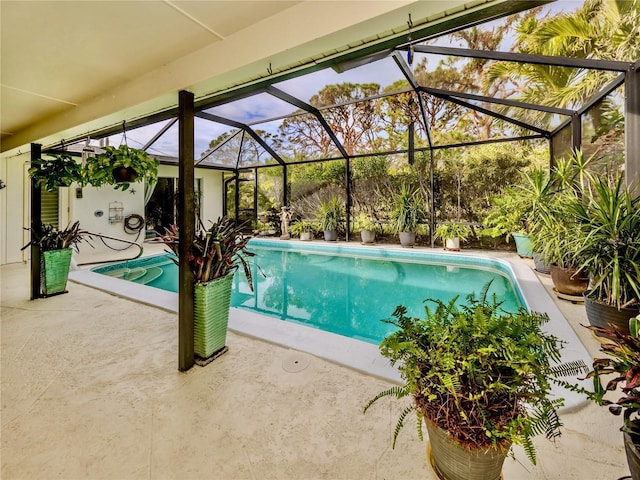 view of pool with a patio area and a lanai