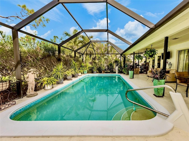 view of pool with a lanai, ceiling fan, and a patio