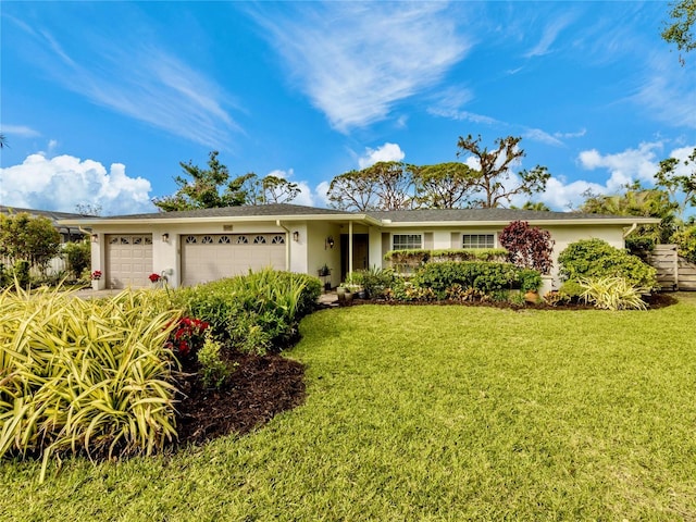 single story home with a front yard and a garage