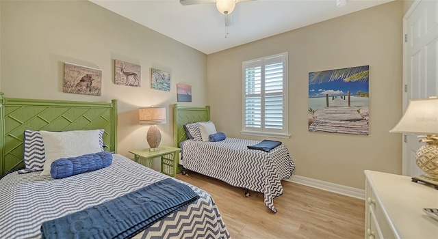 bedroom with ceiling fan and light hardwood / wood-style floors