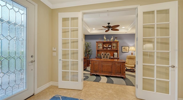 interior space featuring ceiling fan, a raised ceiling, crown molding, a healthy amount of sunlight, and french doors