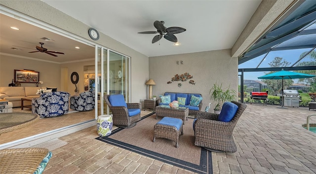 view of patio / terrace featuring ceiling fan, an outdoor living space, area for grilling, and glass enclosure