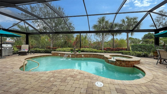 view of swimming pool featuring pool water feature, a patio area, area for grilling, a lanai, and an in ground hot tub