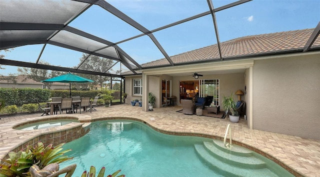 view of swimming pool featuring a lanai, a patio, ceiling fan, and an in ground hot tub