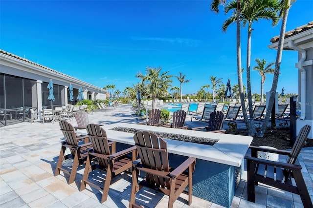 view of patio / terrace featuring a community pool and an outdoor fire pit