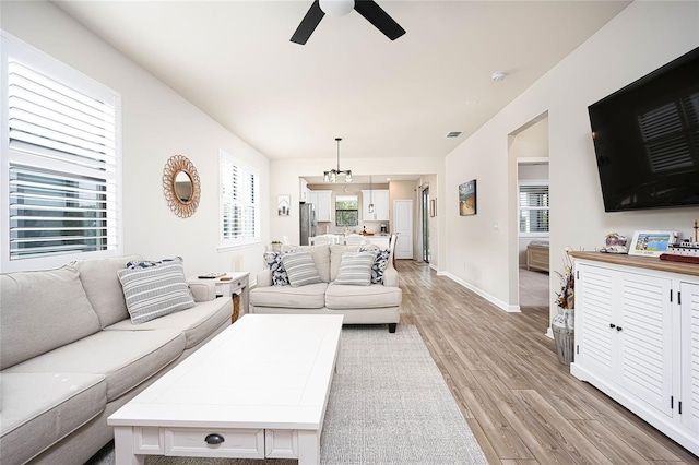 living room with ceiling fan and light hardwood / wood-style floors