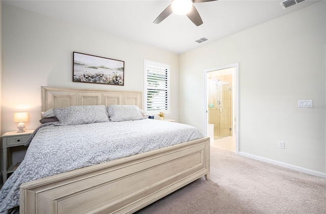 bedroom featuring ceiling fan, light colored carpet, and connected bathroom