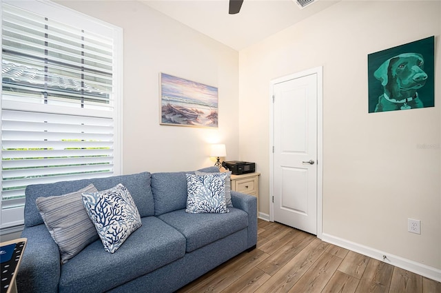 living room featuring hardwood / wood-style flooring and ceiling fan