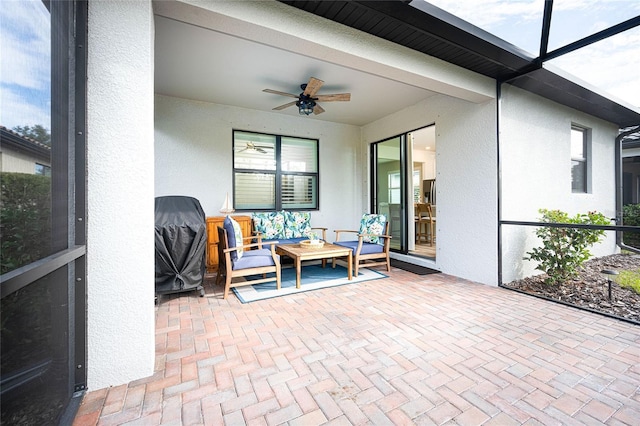 sunroom / solarium featuring beam ceiling and ceiling fan