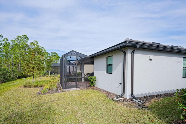 exterior space featuring a lanai and a lawn