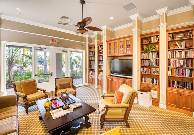 carpeted living room featuring ceiling fan and ornamental molding