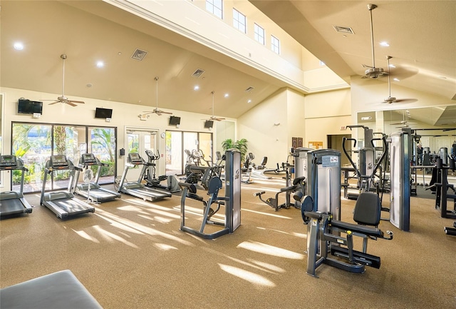 workout area with ceiling fan and high vaulted ceiling