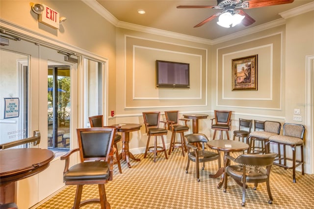 interior space featuring crown molding, carpet floors, and ceiling fan