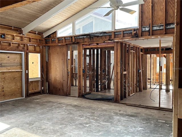 miscellaneous room featuring vaulted ceiling, wooden walls, and ceiling fan