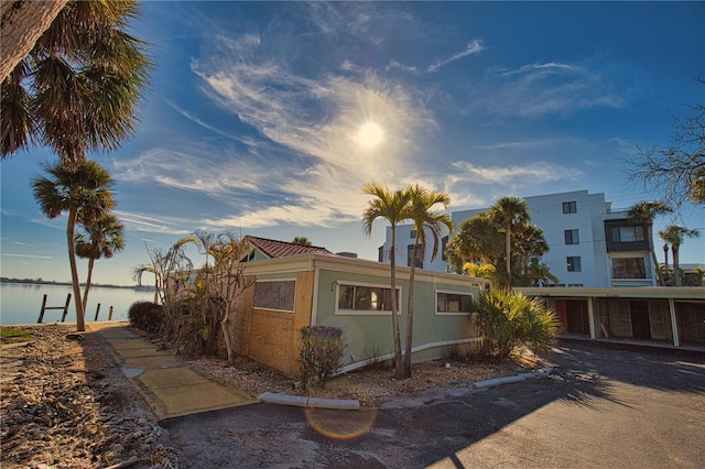 view of side of home with a water view