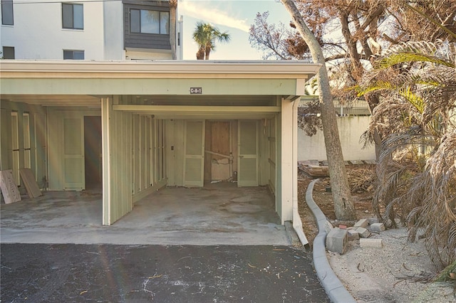 doorway to property with a carport