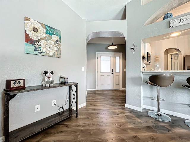 foyer featuring dark hardwood / wood-style floors and a towering ceiling