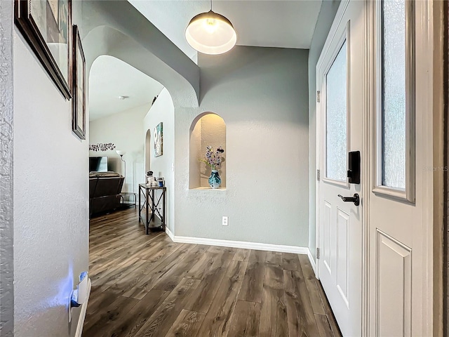 hallway with dark hardwood / wood-style flooring