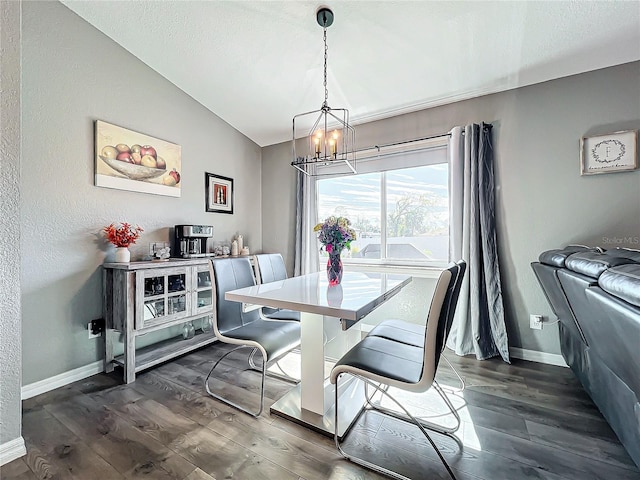 dining room featuring dark hardwood / wood-style floors, vaulted ceiling, a textured ceiling, and a notable chandelier