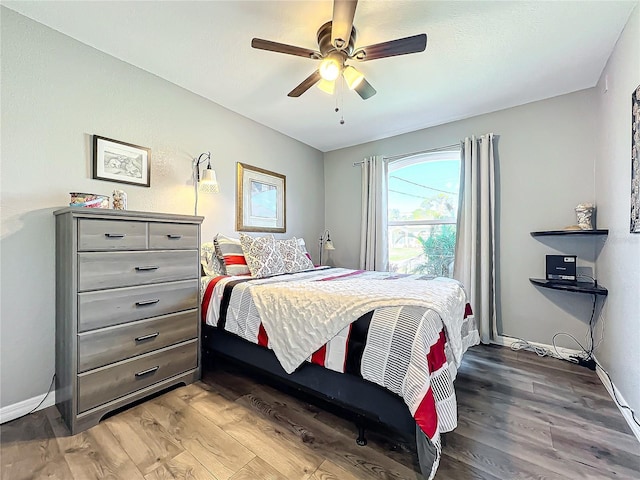 bedroom with wood-type flooring and ceiling fan