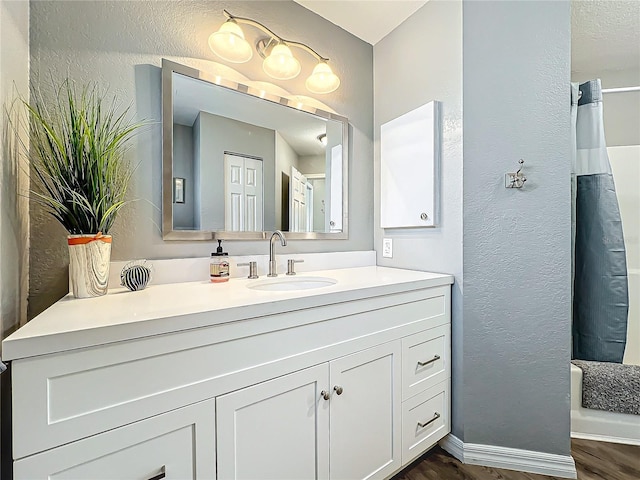 bathroom with vanity and hardwood / wood-style floors