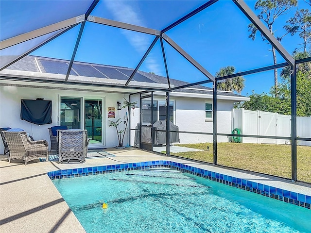 back of house with a fenced in pool, a yard, glass enclosure, and a patio area