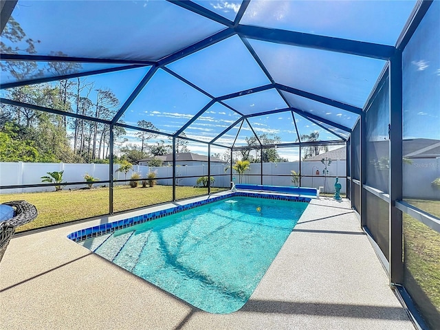 view of swimming pool featuring a patio, a lanai, and a yard