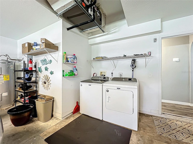 laundry area featuring water heater and independent washer and dryer