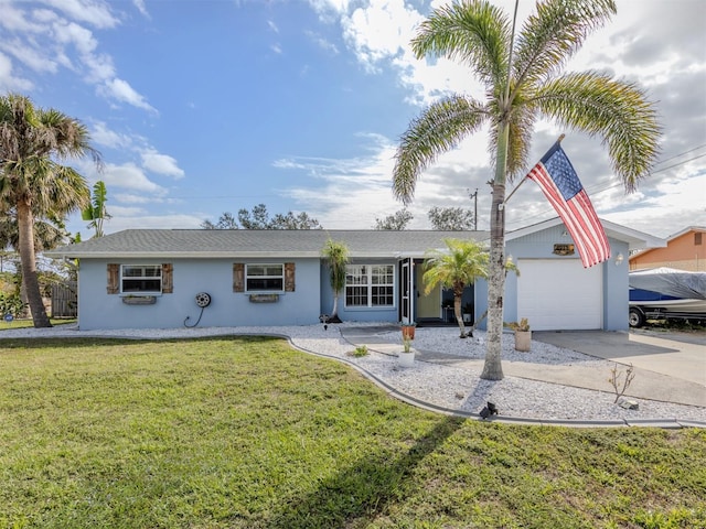 single story home featuring a garage, a front yard, concrete driveway, and stucco siding