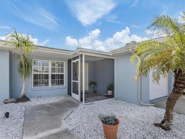 exterior space featuring a sunroom and stucco siding